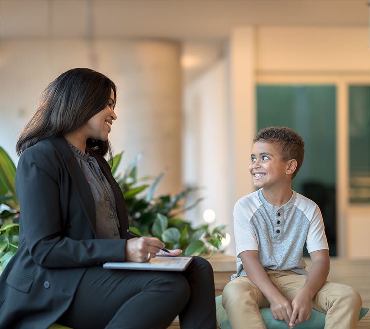 clinician with child in her office